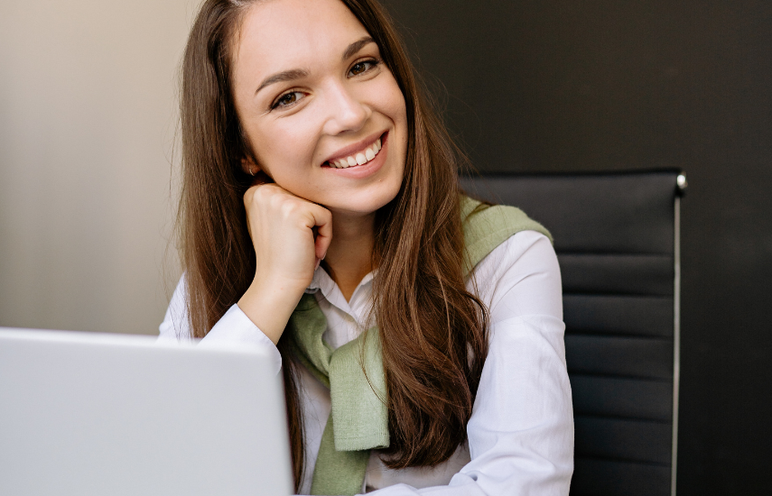 Young professional woman at laptop smiling
