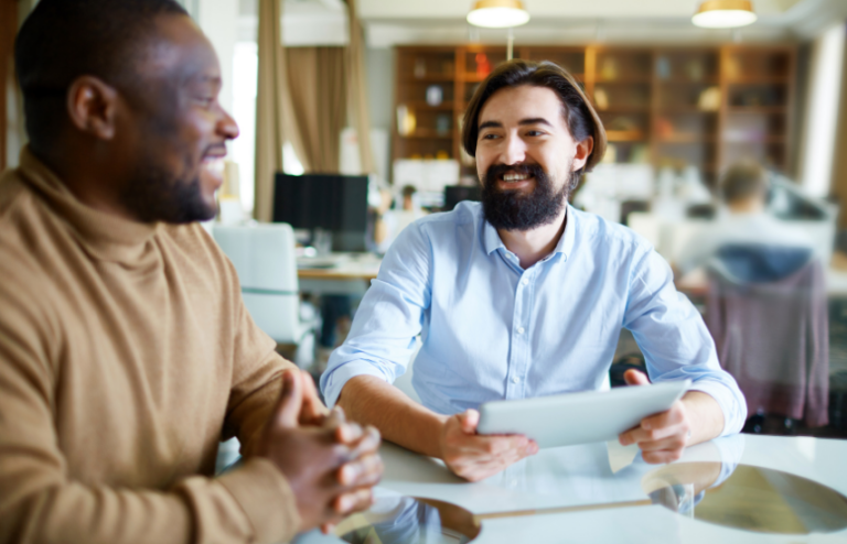 Two men smiling discussing business