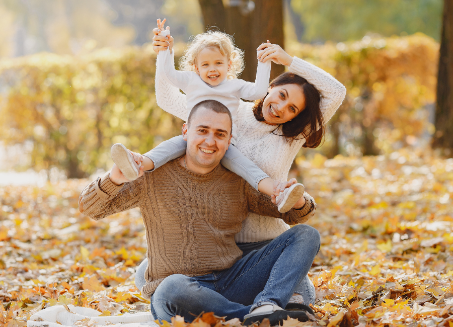 Family enjoying fall leaves