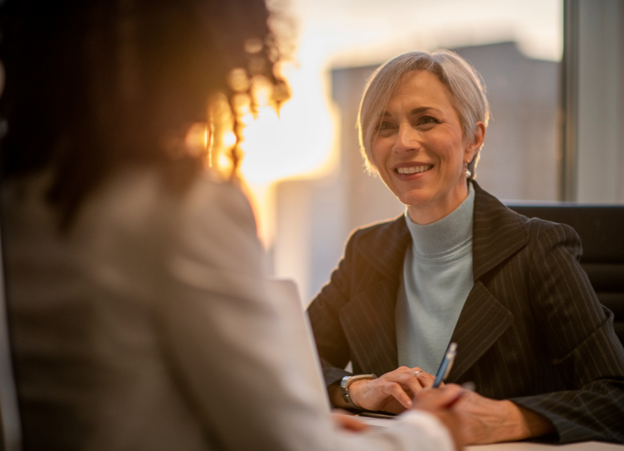 Professional woman talking to another woman